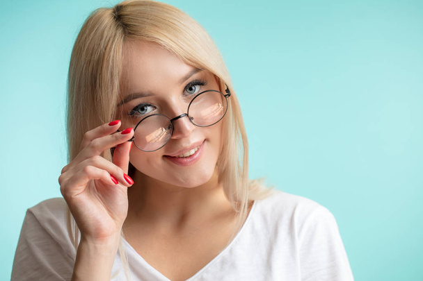 closeup portrait of happy blond girl wearing glasses - Photo, Image