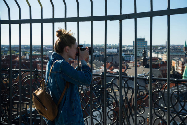 selective focus of young woman taking picture of copenhagen city, denmark - 写真・画像