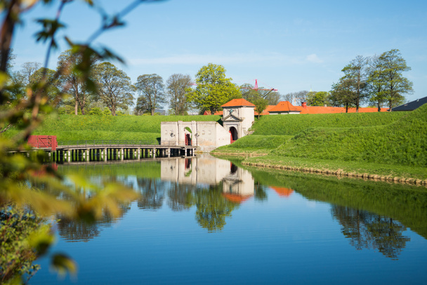 gates to famous Kastellet or Citadel reflected in calm water, copenhagen, denmark - Photo, Image