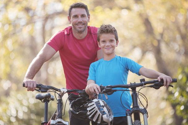 Portrait father and son bike riding - Photo, Image