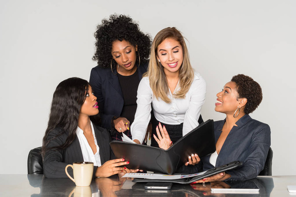 Group of four minority businesswomen working together in the office - Φωτογραφία, εικόνα