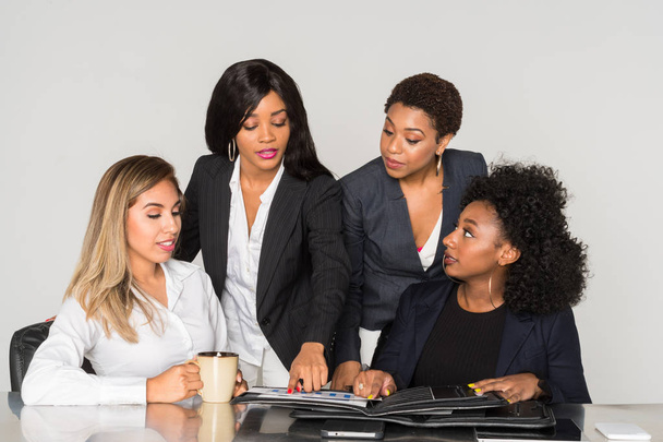 Group of four minority businesswomen working together in the office - Photo, Image