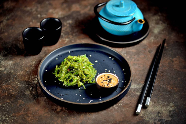 Japanese seaweed salad with nut sauce and sesame seeds. - Photo, Image