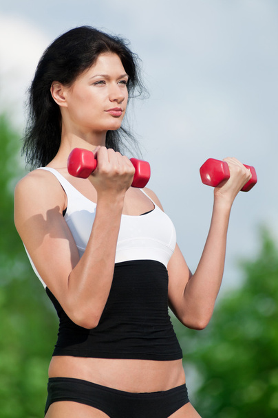 Woman doing exercise with dumbbell - 写真・画像