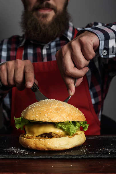 Man eating fresh self made burger close up - Foto, Imagen