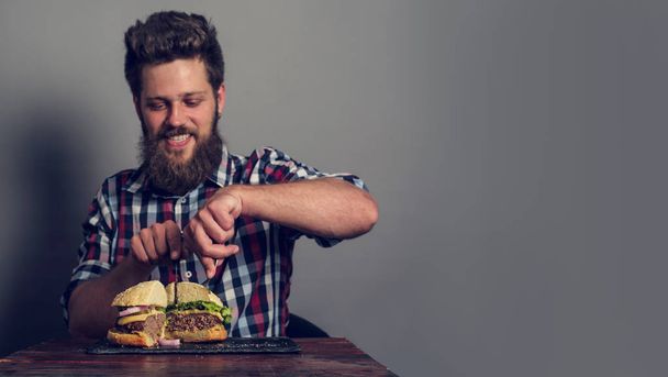 Man eating fresh self made burger close up - Foto, imagen