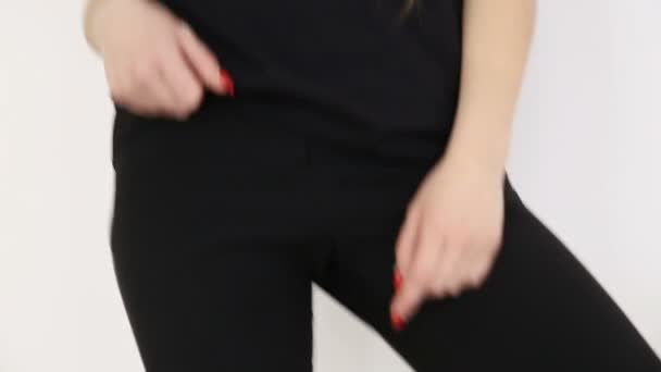 a teenage girl in black hip-hop clothes and a cap dances at the white wall- close-up, handheld shoot, small depth of field - Footage, Video