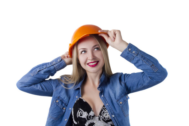 Young woman in a construction orange helmet - Foto, Bild