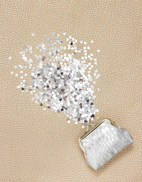 Silver purse and glitter hearts on leather background. Wealth concept. - Photo, Image