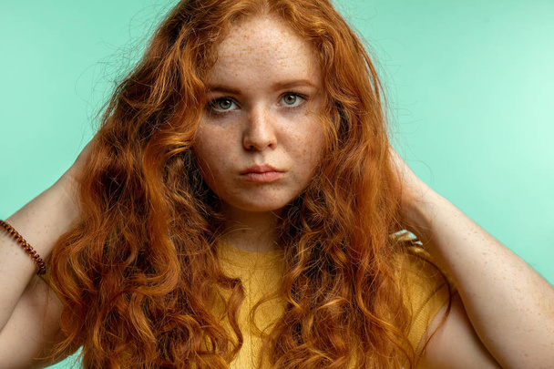 Upset and woman with her damaged dry hair face expression blue background - Фото, зображення