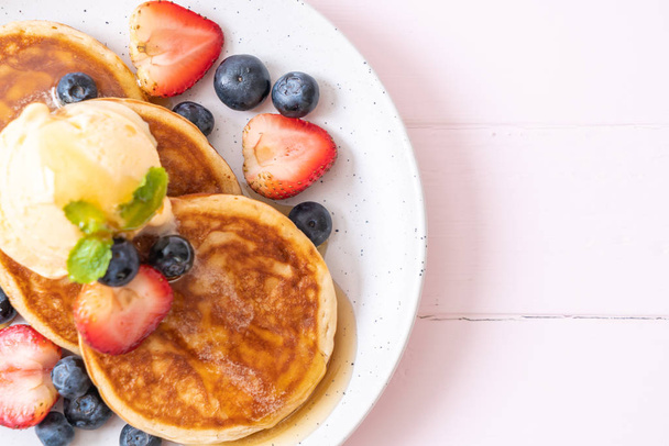 souffle pancake with blueberries, strawberries, honey and vanilla ice-cream - Photo, image