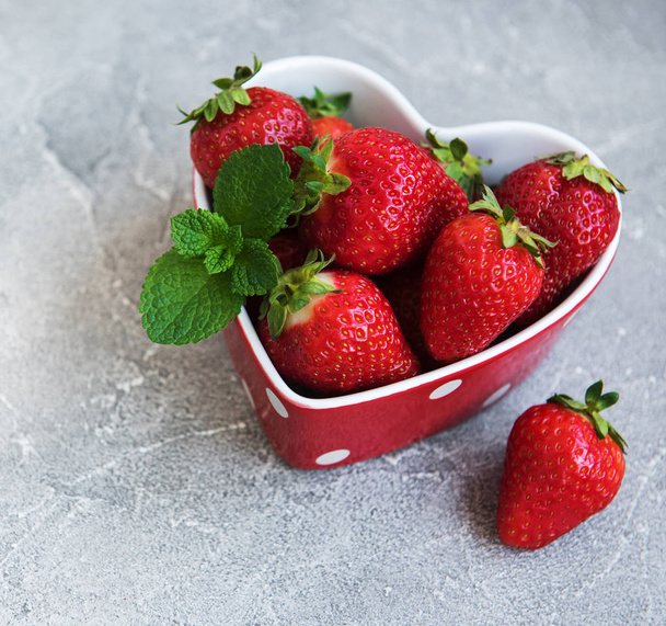 Fresh strawberries on a bowl in the shape of heart - Fotografie, Obrázek