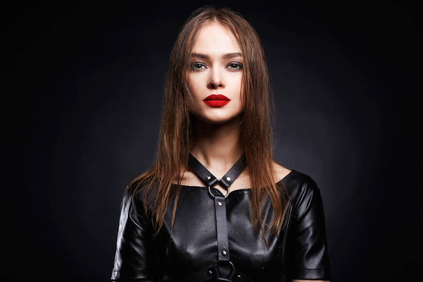 革でセクシーな美しい若い女性。美容メイク女の子、赤い唇、swordbelt - 写真・画像