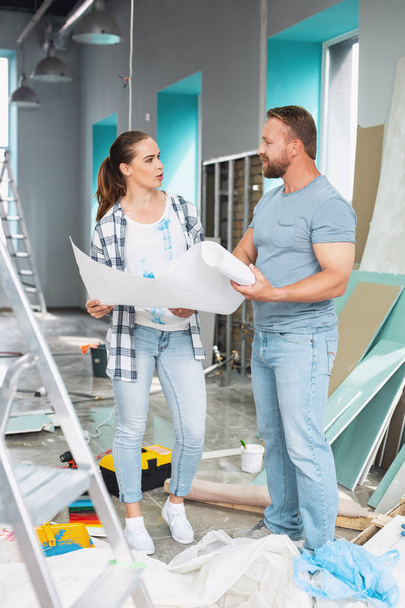 Serious man discussing renovations with a woman - Photo, Image
