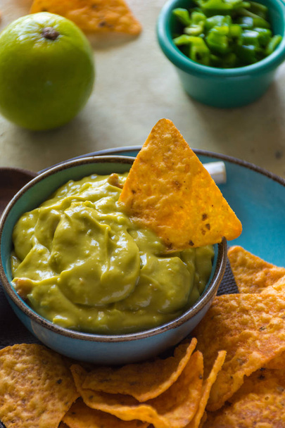 Plate of homemade guacamole with nachos. Typical dish of the mexican food - Zdjęcie, obraz