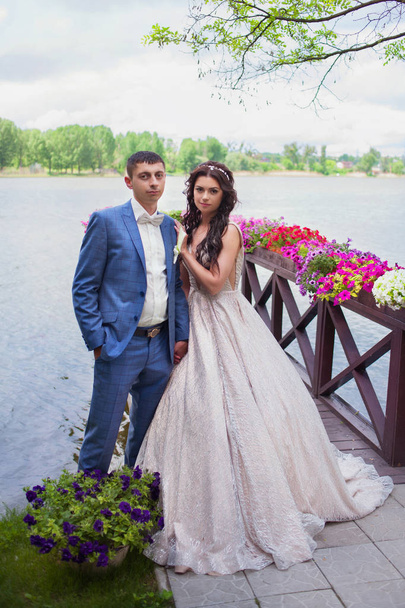 beautiful happy young bride and groom celebrating wedding outdoor - Fotografie, Obrázek