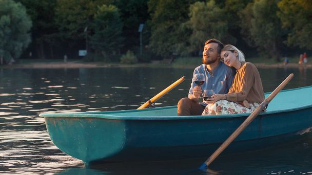 Young couple in a boat outdoors - Фото, изображение