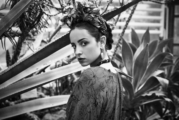 Black and white portrait of gorgeous young woman in stylish floral headdress - 写真・画像