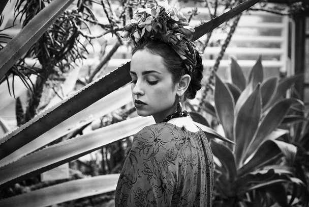 Black and white portrait of gorgeous young woman in stylish floral headdress - 写真・画像