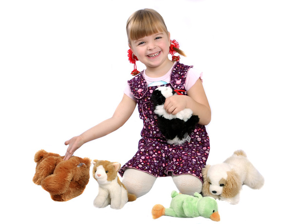 Girl with soft toys - Foto, afbeelding
