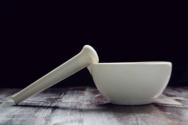 mortar and pestle on black background - Foto, afbeelding