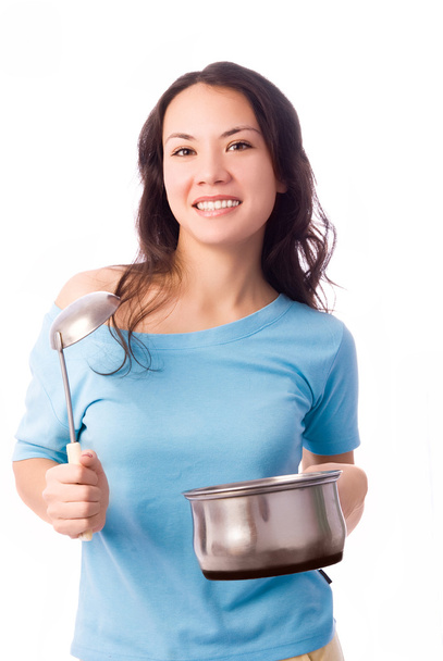 Beautiful girl with a serving spoon and pan in - Foto, immagini