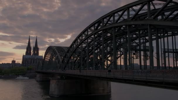 Pan from Hohenzollernbrucke and Cologne Cathedral across the Rhine in Germany at sunset.  - Footage, Video