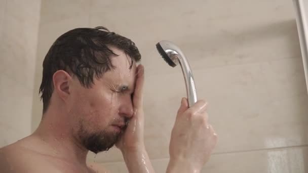 Man keeps himself clean in shower. - Video