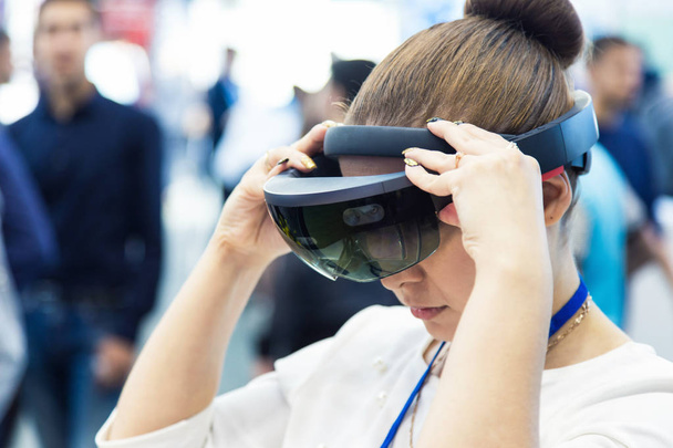 A young woman uses virtual reality glasses - Φωτογραφία, εικόνα