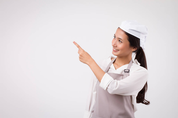 happy smiling confident asian woman pointing up, domestic worker pointing, domestic helper, woman housekeeper, girl shopkeeper, housewife pointing up, girl cleaner suggesting, woman maid, girl cleaner - Photo, Image
