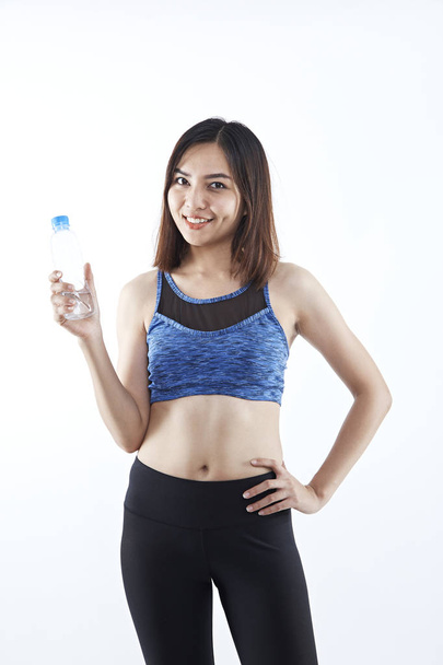Sports and exercise will give one good health and strength. Asian woman smiling sports bras outfit. Beauty face and natural makeup isolated over white background - Foto, Imagem