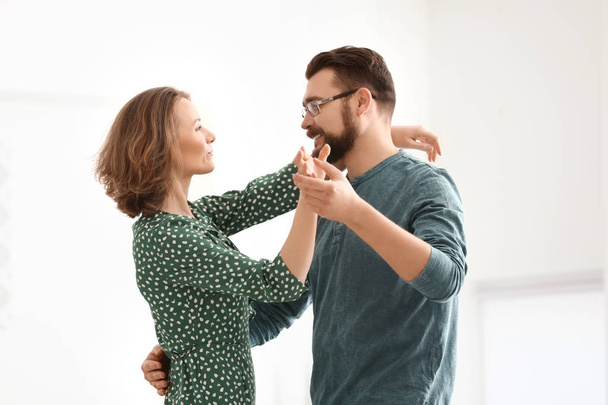 Lovely couple dancing together at home - Foto, afbeelding