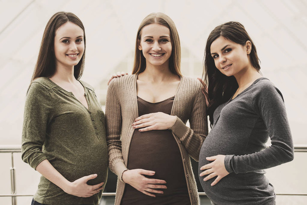 Portrait of three young happy pregnant girls. - Photo, image