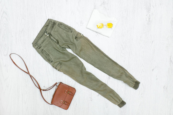 Khaki-Hosen, Handtasche und Sonnenbrille. Modisches Konzept - Foto, Bild