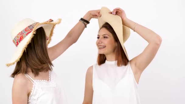 Two beautiful women wearing large summer hats - Footage, Video