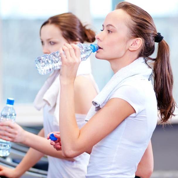 Women drinking water after sports - Fotó, kép