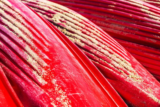 Heap of red kayaks or boats of plastic as abstract background - Photo, Image