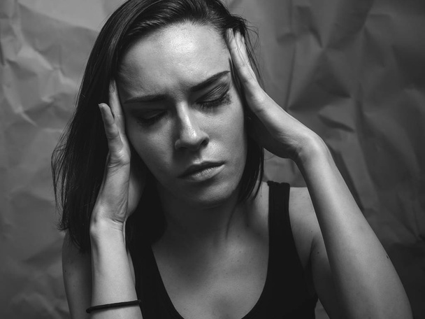 Headache or stress. Portrait of young woman - Foto, Imagen