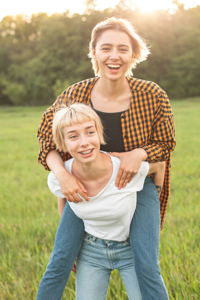Two cheerful young women having fun outdoors - Фото, зображення