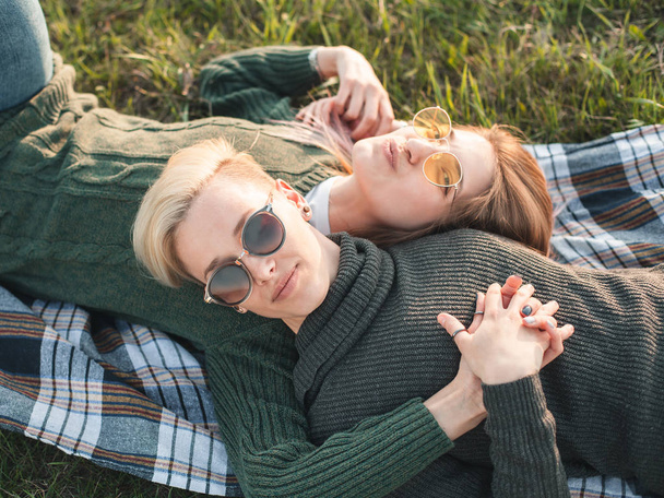 Two women are lying on the grass. Best friends - Valokuva, kuva