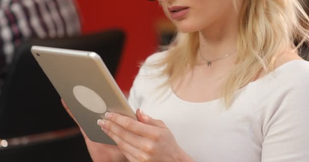 Successful business woman working at the office. Gorgeous young businesslady in glasses at her workplace using tablet computer - Materiał filmowy, wideo