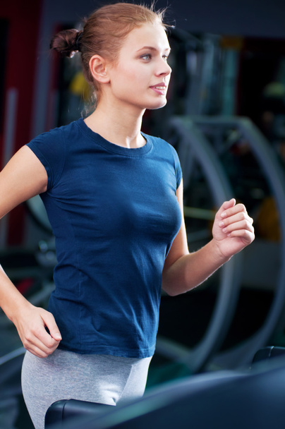 Young woman at the gym run on on a machine - Φωτογραφία, εικόνα