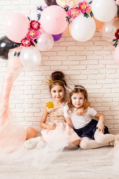 little princesses sitting  under balloons - Photo, Image