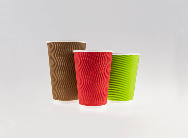 three colored coffee cups on a gray background - 写真・画像