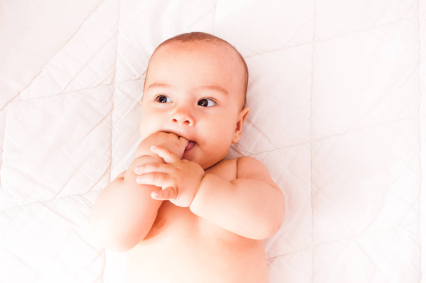 Toddler with a finger in the mouth - Photo, Image