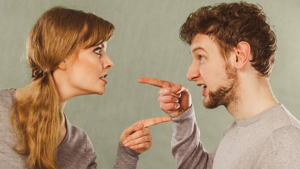 Bad relationship and divorce. Expressive young couple yelling shouting. Husband and wife having big emotional argue split quarrel. - Фото, изображение