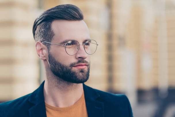 Portrait with copy-space of smart thoughtful man with modern hairdo beard looking away isolated on blurred background. People person society authority concept - Fotografie, Obrázek
