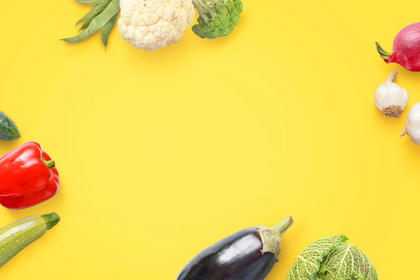 Flat lay vegetables composition on yellow surface with free space for text. View from above. - Photo, Image