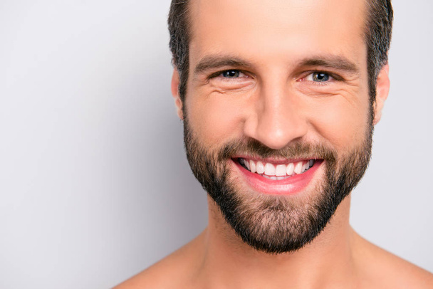 Close up cropped portrait with copy space of cheerful, joyful, virile, manly, attractive, naked, unshaven, handsome, stunning man with ideal, perfect face skin, looking at camera over gray background - Photo, Image
