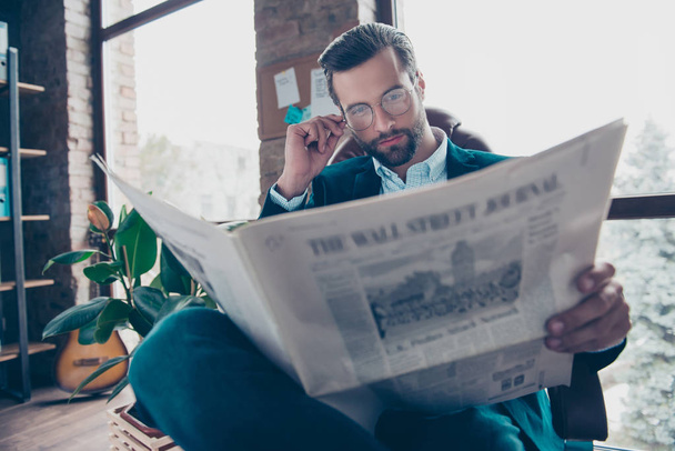 Portrait of successful professional attractive thoughtful pensive dreamy confident clever manager dressed in formal outfit clothes reading newspaper at workplace near window - Φωτογραφία, εικόνα